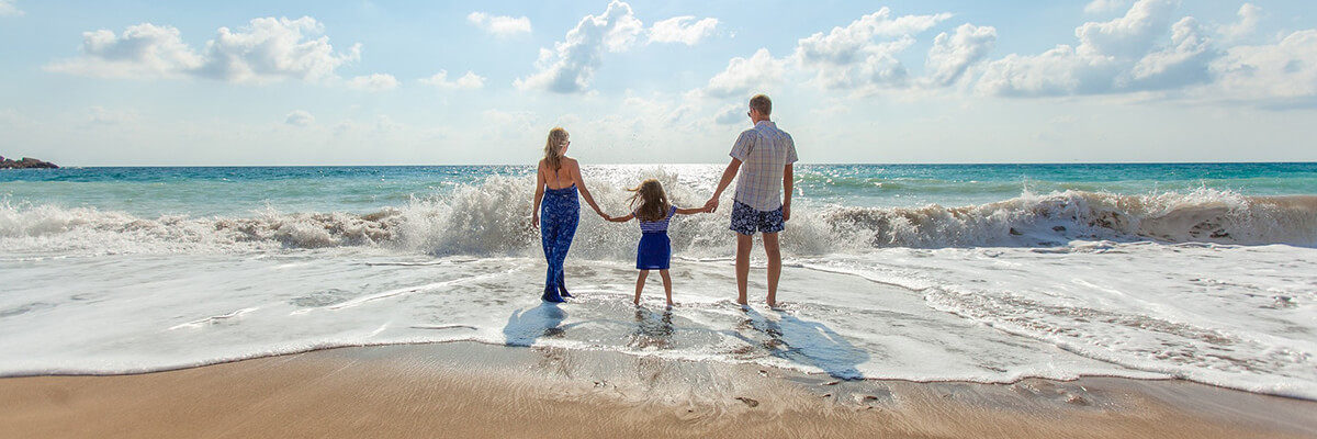 Family Walking On Beach